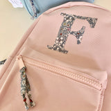 Pale pink initial backpack